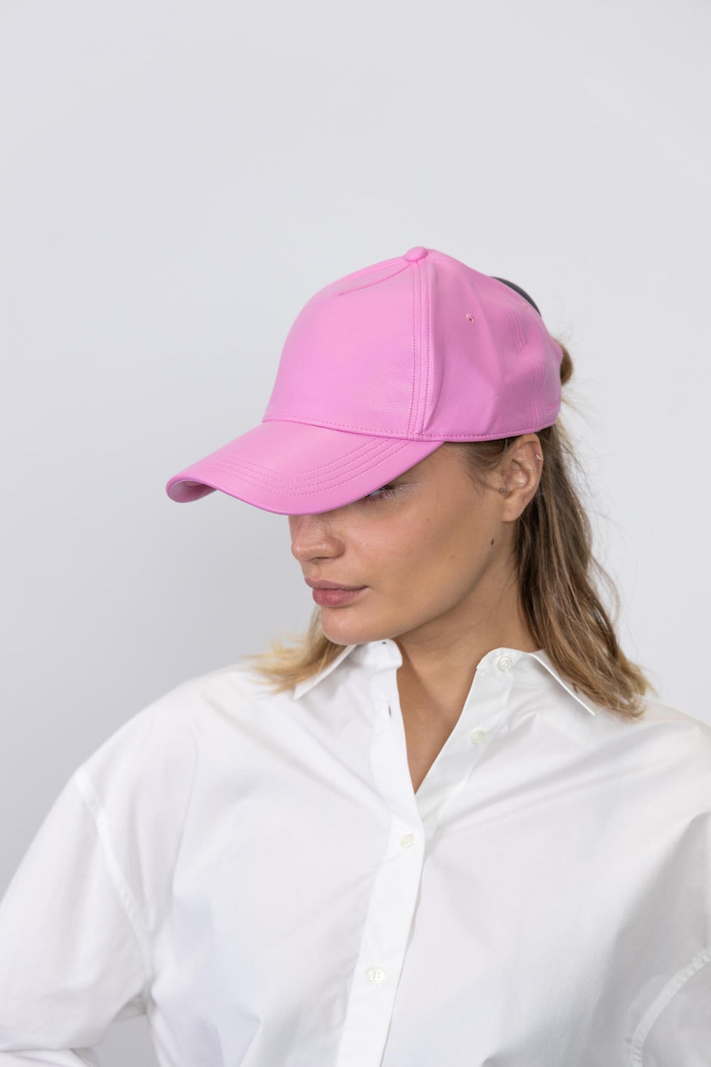 CONNIE FAUX LEATHER CAP IN PINK CAP STAND STUDIO 