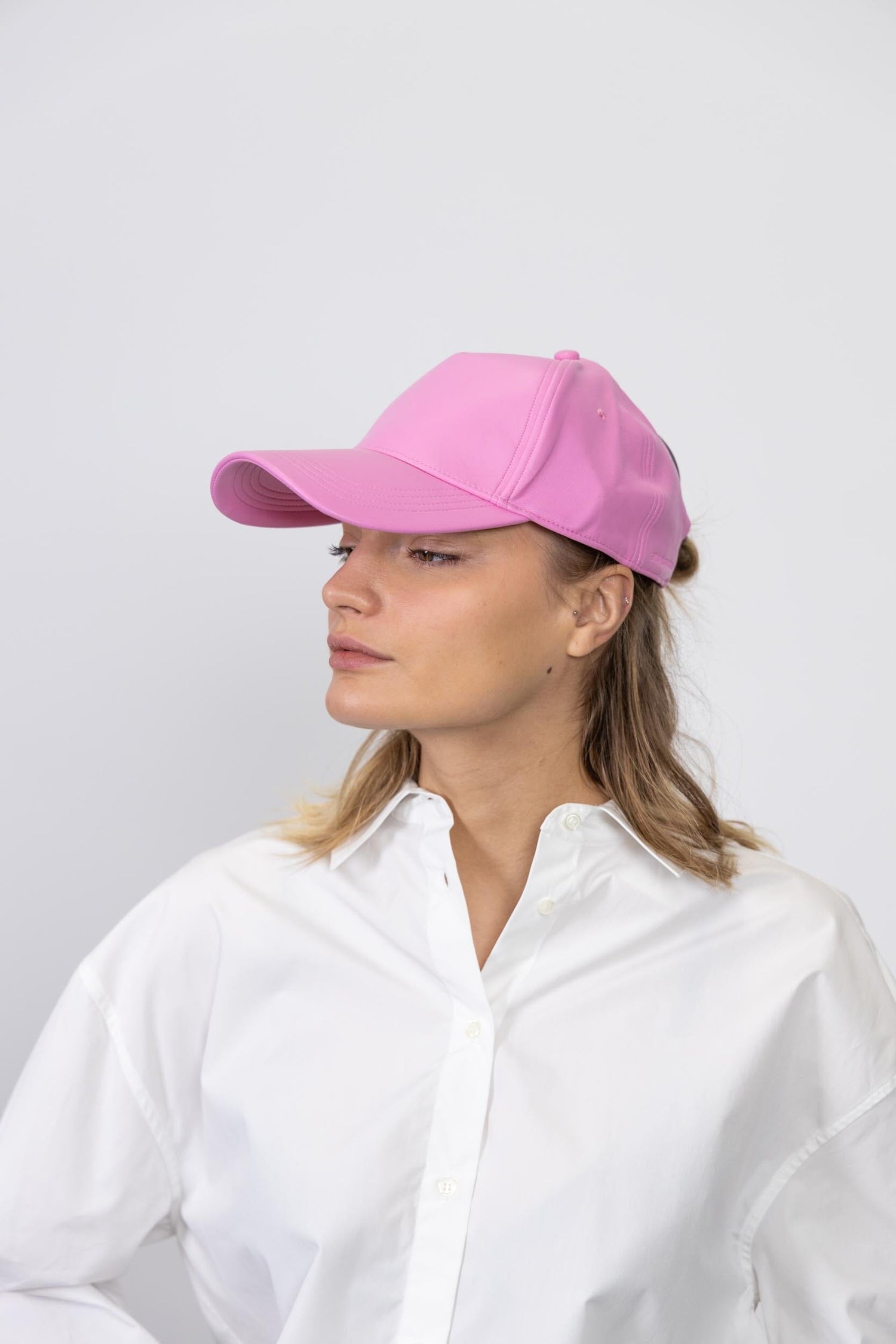 CONNIE FAUX LEATHER CAP IN PINK CAP STAND STUDIO 